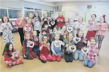  ??  ?? St Nicholas Wednesday Brownies turned red for the evening. They enjoyed working together to create Friendship Bears and to decorate heart wreaths to give to someone special to them. They also welcomed Aliyah to the pack.