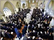  ?? ?? The casket of Brian Fraser proceeds into the church as family members, friends, and supporters gather at the funeral mass for Fraser at St. Paul on the Lake Catholic Church in Grosse Pointe Farms, Mich., on Saturday.