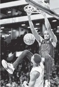  ?? AP ?? INCOMING! Nic Claxton throws down a dunk over Toronto’s Christian Koloko during the second half of the Nets’ victory Friday.