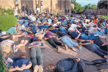  ?? EDDIE MOORE/JOURNAL ?? Hundreds of people marched to the Cathedral Basilica of St. Francis in Santa Fe on June 3 during a Black Lives Matter protest, then lay down with their hands behind their backs in protest of George Floyd’s death while in Minneapoli­s police custody.