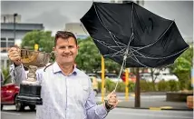  ?? VANESSA LAURIE/STUFF ?? New Plymouth district mayor Neil Holdom said it felt like it had rained every day since he received the cup for sunniest region in New Zealand for 2021 but was happy Taranaki was on its way to holding the title.