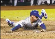  ?? Ross D. Franklin Associated Press ?? DODGERS’ TIM LOCASTRO slides across home plate to score in the seventh inning.