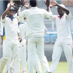  ??  ?? Members of the Jamaica Defence Force team celebrate after Andre McCarty was bowled for a duck by Joseph Palmer on the first day of the two-day Senior Cup final against Melbourne at Sabina Park on Saturday, July 22.