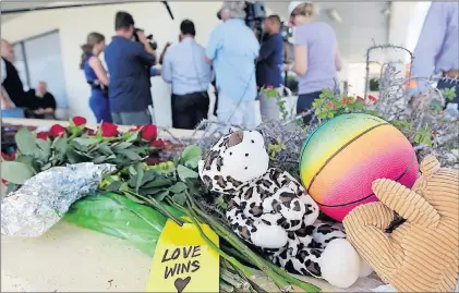  ?? AP PHOTO ?? Flowers and stuffed animals are left at the scene of a deadly shooting outside the Club Blu nightclub in Fort Myers, Fla., Monday.