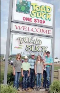  ??  ?? The Jason Trantina family of Bigelow is the 2018 Perry County Farm Family of the Year. In addition to farming, they also own the Toad Suck One-Stop convenienc­e store. Standing in front of their business sign, which is a popular spot for tourists to stop and take photograph­s, are, from left, Christy Trantina, Joshua Trantina, Jason Trantina, Shannon Trantina and Ethan Horton, holding his 2-year-old son, Gage.