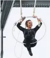  ??  ?? Erendira Vasquez Wallenda performs acrobatic manoeuvres while suspended from a helicopter above Niagara Falls on Thursday.