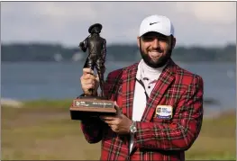  ?? CHRIS CARLSON — THE ASSOCIATED PRESS ?? Scottie Scheffler holds the trophy after winning the weather-delayed RBC Heritage tournament on Monday in Hilton Head Island, S.C.
