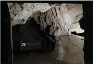  ??  ?? A man shines a light in the abandoned Wanling cave near Manhaguo village in southern China’s Yunnan province. Villagers said the cave had been used as a sacred altar presided over by a Buddhist monk — precisely the kind of contact between bats and people that alarms scientists.