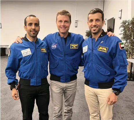  ?? Mohammed bin Rashid Space Centre ?? Maj Hazza Al Mansouri, left, and Dr Sultan Al Neyadi with Nasa astronaut Reid Wiseman, who presented the Emiratis with their Nasa astronaut pins after they completed a basic training programme that qualifies them for projects on the ISS