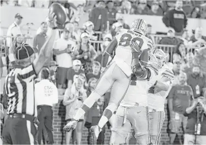  ?? Scott Halleran / Getty Images ?? Noah Brown gets a lift from Jamarco Jones after scoring one of his four touchdowns for Ohio State against Oklahoma.