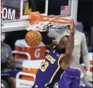  ?? AP photo ?? LeBron James of the Lakers dunks during the first half of Los Angeles’ 116-105 win over the Charlotte Hornets on Thursday.