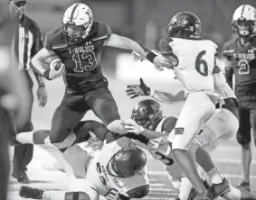  ?? PHOTOS BY BRYAN TERRY/THE OKLAHOMAN ?? Norman North's Gavin Frakes is pushed out of bounds during a 41-24 win against Norman on Thursday.