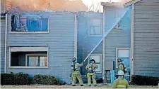  ?? [PHOTO BY BRYAN TERRY, THE OKLAHOMAN] ?? Oklahoma City firefighte­rs work to control a fire at the Village at Stratford Apartments last week. This fire was not fatal.