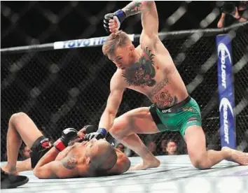  ?? USA Today Sports ?? Down and out Conor McGregor lands punches to win by technical knockout against Jose Aldo during their UFC 194 at MGM Grand Garden Arena in Las Vegas on Saturday night.