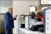  ?? JASON ALLEN/AP ?? While Vine City residents and city officials were meeting on stopping gun violence, Republican presidenti­al candidate Donald Trump showed up at a nearby Chickfil-A for milkshakes and chicken.