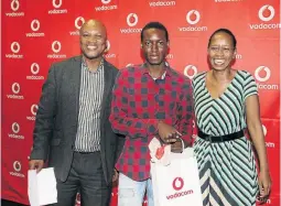  ?? /SUPPLIED ?? Reginald Champala at the Vodacom bursary achievers awards, with Vodacom’s Mthobeli Tengimfene and Takalani Netshitenz­he.