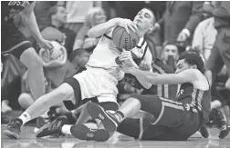  ??  ?? Louisville’s Ryan McMahon, left, scrambles for a loose ball with USC Upstate’s Josh Aldrich on Wednesday in Louisville, Ky.