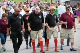  ?? MARIAN DENNIS – DIGITAL FIRST MEDIA ?? Representa­tives from area fire department­s sported all kinds of high heels as they took the mile walk around the Pfizer campus in Collegevil­le.