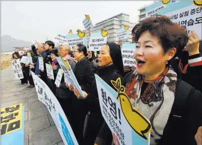  ?? Ahn Young-joon ?? The Associated Press Protesters stage a rally demanding peace Monday on the Korean Peninsula near the U.S. Embassy in Seoul, South Korea.