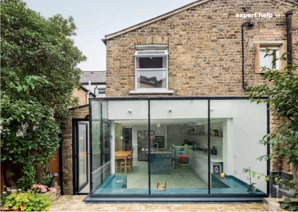  ??  ?? Above: This sleek glass box extension was designed by Unagru to make the most of the house’s connection with the back garden