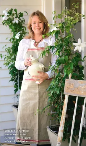  ??  ?? Meredith on her front veranda with white clematis planted in pots either side of the door.