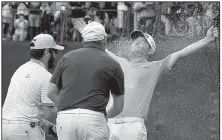  ?? AP/THEMBA HADEBE ?? Branden Grace is sprayed with champagne Sunday after winning the Nedbank Golf Challenge by one stroke over Scott Jamieson in Sun City, South Africa.