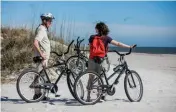  ??  ?? BELOW: Biking through Egans Creek Greenway Park on Amelia Island. RIGHT: Driving along beautiful Magnolia Street in St. Augustine. BOTTOM: Shopping on Aviles Street in St. Augustine.