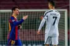  ?? AP PHOTO/JOAN MONFORT ?? Barcelona’s Lionel Messi, left, shakes hands with Juventus’ Cristiano Ronaldo prior of the start of the Champions League group G soccer match between FC Barcelona and Juventus at the Camp Nou stadium in Barcelona, Spain, Tuesday.