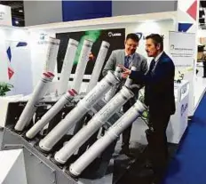  ?? Abdul Rahman./Gulf News ?? Officials of Lacroix show Sylena Launchers for dual antimissil­e and anti-torpedo systems for ships at the French pavilion.