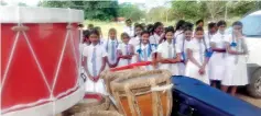  ??  ?? All smiles: The eager students of Gamini Public School survey their new instrument­s