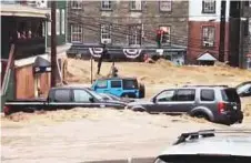  ?? AP ?? Water rushing through Main Street in Ellicott City, Maryland, on Sunday. Flash flooding and water rescues are being reported as heavy rain soaks most of the state.