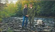  ?? GEORGE ETHEREDGE/THE NEW YORK TIMES ?? Anna Aberg and Tom Roberts, co-founders of the Livingston Manor Fly Fishing Club, hang out with their dog Biscuit on the river in Livingston Manor, New York.