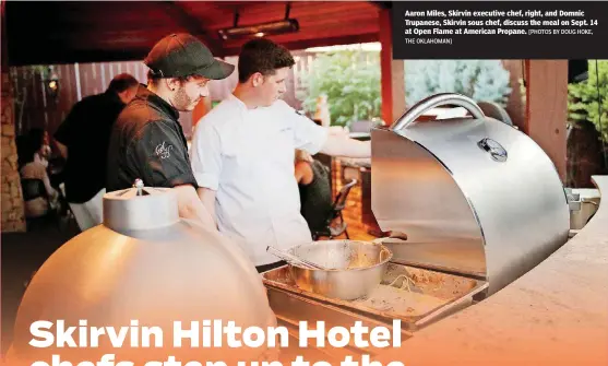  ?? [PHOTOS BY DOUG HOKE, THE OKLAHOMAN] ?? Aaron Miles, Skirvin executive chef, right, and Domnic Trupanese, Skirvin sous chef, discuss the meal on Sept. 14 at Open Flame at American Propane.