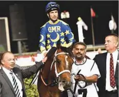  ?? Virendra Saklani/Gulf News ?? Paddy’s Day, ridden by Patrick Dobbs, after winning the Mazrat Al Ruwayah race at the Meydan.