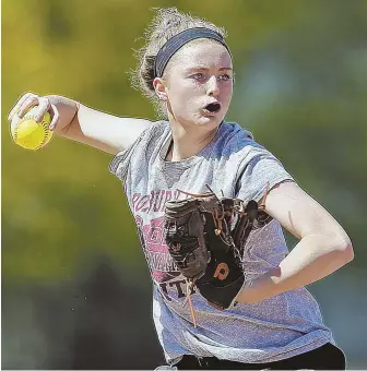  ?? STAFF PHOTO BY MATT STONE ?? DRAGON THROWING FIRE: Latin Academy junior third baseman Michaela Russell, who has played in every single Dragons game since the seventh grade, works on an infield drill during practice at Playstead Field on Monday.