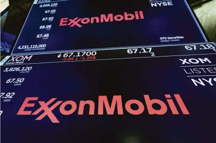  ?? Richard Drew / Associated Press 2019 ?? Making big cuts in emissions doesn’t add value for shareholde­rs of ExxonMobil and other fossil fuel companies.