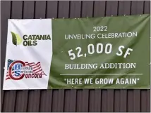  ?? ?? A banner hung at Catania Oils, celebratin­g the company’s latest expansion in Ayer on Tuesday.