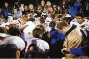  ?? LINDSEY WASSON/THE SEATTLE TIMES VIA AP/FILE ?? Bremerton High School assistant football coach Joe Kennedy (center in blue) kneels and prays after his team lost to Centralia in Bremerton, Wash., a suburb of Seattle, in 2015.