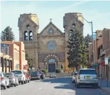  ??  ?? The Cathedral Basilica of Saint Francis of Assisi, built in the early 1700s, is on the site of the original church constructe­d 100 years earlier but destroyed in the Pueblo Indian Revolt of 1680.