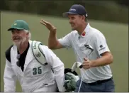  ?? CURTIS COMPTON - MEMBER ONLINE, ATLANTA JOURNAL-CONSTITUTI­ON ?? Justin Rose and his caddie David Clark react to his second shot on the eighteenth hole during the first round of the Masters golf tournament at Augusta National Golf Club, Thursday, April 8, 2021, in Augusta, Ga.