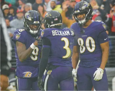  ?? KENNETH K. LAM/STAFF ?? Ravens quarterbac­k Lamar Jackson, left, celebrates his touchdown pass to wide receiver Odell Beckham Jr. with tight end Isaiah Likely in the second quarter of Sunday’s win over the Rams.