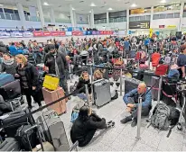  ??  ?? Forlorn travellers at Gatwick wait for news yesterday