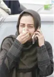  ?? — AFP ?? A relative mourns near Tehran’s Mehrabad airport on Sunday.