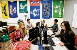  ??  ?? Interns (from left) Alissa Beckett from KSU, Kasra Falahati from GSU, Gurmesa Shakme from GSU and Esther Shin from GSU learn communicat­ions and “soft skills” at InComm, a financial services company, in Atlanta.