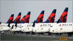  ?? CHARLIE RIEDEL / ASSOCIATED PRESS FILE (2020) ?? Delta Air Lines jets are parked April 1, 2020, at Kansas City Internatio­nal Airport in Kansas City, Mo.