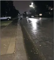  ?? KATHY GRANT/COURTESY PHOTOGRAPH ?? Runoff from Friday morning’s rainfall flows along a Lodi street.