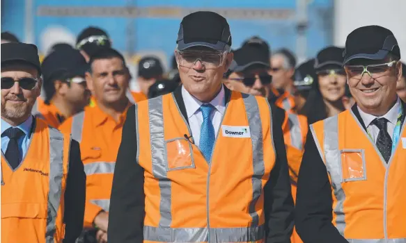  ?? Picture: AAP IMAGE ?? Prime Minister Scott Morrison (centre) visits the Downer EDI Rail Auburn Maintenanc­e Centre in Sydney yesterday to woo support.