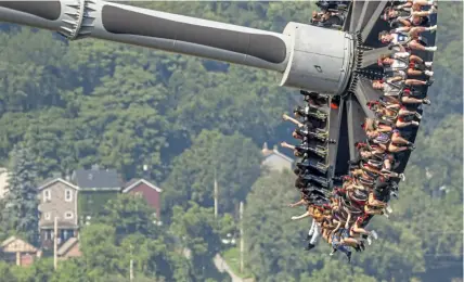  ?? Steve Mellon/Post-Gazette ?? Kennywood Park’s Black Widow ride, a developmen­t of George Ferris’ wheel, propels riders at 68 miles an hour to a height of 146 feet, according to the park’s web site.