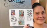  ??  ?? Martina Prinz of the Austrian Post shows this year’s collection of Christmas post stamps and marks at the post office in the village of Christkind­l.