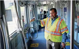  ?? [PHOTO BY DOUG HOKE, THE OKLAHOMAN] ?? Operations manager Joel Garcia explains features on the streetcar.